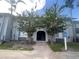 Two-story condo building featuring well-kept landscaping, a sidewalk and palm trees at 4745 S Texas Ave # A, Orlando, FL 32839