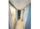 Hallway with doors leading to a bathroom, laundry, and a closet space at 4745 S Texas Ave # A, Orlando, FL 32839
