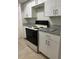 Kitchen featuring white cabinets, laminate counters and a black range at 4745 S Texas Ave # A, Orlando, FL 32839