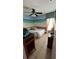 Nautical-themed bedroom featuring a mural, ceiling fan, and ample natural light at 639 Gull Dr, Poinciana, FL 34759