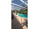 Screened in pool with palm trees and an outdoor seating area at 639 Gull Dr, Poinciana, FL 34759