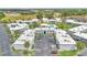 Aerial view of the apartment complex showcasing landscaping, parking and pool at 1038 Plantation Dr # D9, Kissimmee, FL 34741