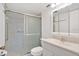 Well-lit bathroom featuring a shower with sliding glass doors and a white vanity at 1038 Plantation Dr # D9, Kissimmee, FL 34741