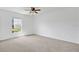 Comfortable bedroom featuring soft carpet, a ceiling fan, and a window for natural lighting at 1038 Plantation Dr # D9, Kissimmee, FL 34741