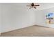 Spacious carpeted bedroom with a ceiling fan, large window, and ample natural light at 1038 Plantation Dr # D9, Kissimmee, FL 34741