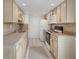 Bright kitchen with light wood cabinets, modern appliances, and tile flooring, well-lit and functional at 1038 Plantation Dr # D9, Kissimmee, FL 34741