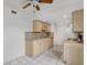 Cozy kitchen featuring light wood cabinets, tile backsplash, and modern appliances at 1038 Plantation Dr # D9, Kissimmee, FL 34741