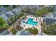 Aerial view of a community pool with plenty of seating surrounded by mature landscaping and palm trees at 1051 S Hiawassee Rd # 2127, Orlando, FL 32835