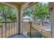 A serene view from the balcony, featuring mature trees and exterior building at 1051 S Hiawassee Rd # 2127, Orlando, FL 32835