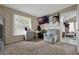 Sun-filled bedroom offers a large window, dresser, mounted television, and comfortable seating at 1051 S Hiawassee Rd # 2127, Orlando, FL 32835