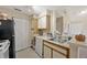 The kitchen has white cabinets, white counters, and leads to an adjacent room at 1051 S Hiawassee Rd # 2127, Orlando, FL 32835