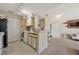 This bright kitchen features neutral cabinets, a breakfast bar, and tile floors at 1051 S Hiawassee Rd # 2127, Orlando, FL 32835
