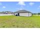 Expansive backyard with a well-maintained lawn and white privacy fence at 1083 Snively Cir, Lake Hamilton, FL 33851