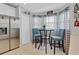 Cozy breakfast nook features a bistro set, stainless steel fridge, and natural light at 1083 Snively Cir, Lake Hamilton, FL 33851