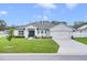 Charming one-story home with a 2-car garage, manicured lawn, and landscaped front yard at 1083 Snively Cir, Lake Hamilton, FL 33851