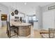 Open-concept kitchen featuring an island, breakfast bar, stainless steel appliances, and adjacent dining area at 1083 Snively Cir, Lake Hamilton, FL 33851