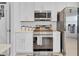 Well-equipped kitchen features stainless steel appliances, white cabinetry, and ample counter space at 1083 Snively Cir, Lake Hamilton, FL 33851