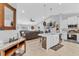 Open-concept living space with tile flooring, vaulted ceilings, kitchen, and comfortable seating at 1083 Snively Cir, Lake Hamilton, FL 33851