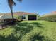 Backyard featuring well-manicured lawn and screen enclosed patio at 12273 Pescara Ln, Orlando, FL 32827
