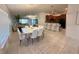 Open-concept dining room flowing into the kitchen with modern tile flooring and plenty of space for entertaining at 12273 Pescara Ln, Orlando, FL 32827