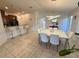Open-concept dining area with stylish lighting, sleek furnishings, and a view of the modern kitchen at 12273 Pescara Ln, Orlando, FL 32827