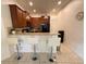 Features a breakfast bar with granite counters, wood cabinets, and pendant lighting at 12273 Pescara Ln, Orlando, FL 32827