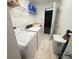 A well-lit laundry room with washer, dryer, and shelving for ample storage at 12273 Pescara Ln, Orlando, FL 32827