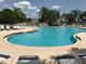 Resort-style pool with ample seating and clear blue water on a sunny day at 12273 Pescara Ln, Orlando, FL 32827