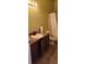 Cozy bathroom featuring a vanity with a sink, and a toilet with a shower and curtain, offering essential amenities at 130 Highland Meadows St, Davenport, FL 33837