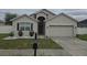 Charming single-story home with neutral stucco, a two-car garage, and well-maintained landscaping at 130 Highland Meadows St, Davenport, FL 33837