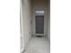 Covered entryway features a gray front door with a transom window and a small porch area at 130 Highland Meadows St, Davenport, FL 33837