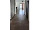 Spacious hallway featuring neutral tile flooring that transitions into the living area with natural light streaming through the glass doors at 130 Highland Meadows St, Davenport, FL 33837