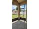 Relaxing screened patio overlooking the backyard, perfect for enjoying the outdoors in comfort and with protection from insects at 130 Highland Meadows St, Davenport, FL 33837