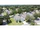Expansive aerial view of a charming home surrounded by lush greenery and a well-manicured lawn at 1301 Rebecca Dr, Haines City, FL 33844