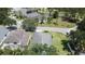 Aerial view showcases a home nestled among mature trees and lush landscaping in a desirable neighborhood at 1301 Rebecca Dr, Haines City, FL 33844