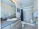 Well-maintained bathroom features a shower stall, neutral decor, and a large mirror at 1301 Rebecca Dr, Haines City, FL 33844