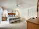 Bright bedroom features ceiling fan, carpeted floor, and an ensuite bathroom at 1301 Rebecca Dr, Haines City, FL 33844