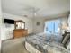 Main bedroom with television, dresser and a sliding glass door to private outdoor pool at 1301 Rebecca Dr, Haines City, FL 33844