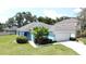 Beautiful single-story home featuring mature landscaping and a two-car garage at 1301 Rebecca Dr, Haines City, FL 33844