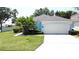 Charming single-story home with well-manicured lawn and mature landscaping at 1301 Rebecca Dr, Haines City, FL 33844