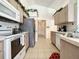 Well-lit kitchen features modern appliances, neutral cabinetry, and tiled floors at 1301 Rebecca Dr, Haines City, FL 33844