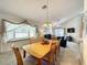 Open living space featuring dining table and comfortable seating in a sunlit home at 1301 Rebecca Dr, Haines City, FL 33844