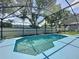 Sparkling pool with tiled edges, surrounded by a screened enclosure for outdoor enjoyment at 1301 Rebecca Dr, Haines City, FL 33844
