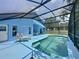 Inviting backyard pool area surrounded by a screened enclosure and patio at 1301 Rebecca Dr, Haines City, FL 33844