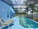 Relaxing outdoor pool area featuring lounge chairs and a screened enclosure at 1301 Rebecca Dr, Haines City, FL 33844