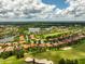 Stunning aerial view of a golf course community with lush landscaping and beautiful homes surrounding a serene lake at 133 Torino Ln, Kissimmee, FL 34759