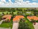 Beautiful aerial view of the homes with tile roofs, landscaping, and golf course at 133 Torino Ln, Kissimmee, FL 34759