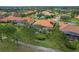 Real estate featuring suburban home with terra cotta roof in well-maintained landscape, near golf course at 133 Torino Ln, Kissimmee, FL 34759