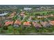 Aerial view of homes in a suburban neighborhood by a golf course and multiple ponds at 133 Torino Ln, Kissimmee, FL 34759