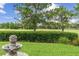 Well-manicured backyard featuring manicured hedges, trees and a decorative fountain at 133 Torino Ln, Kissimmee, FL 34759